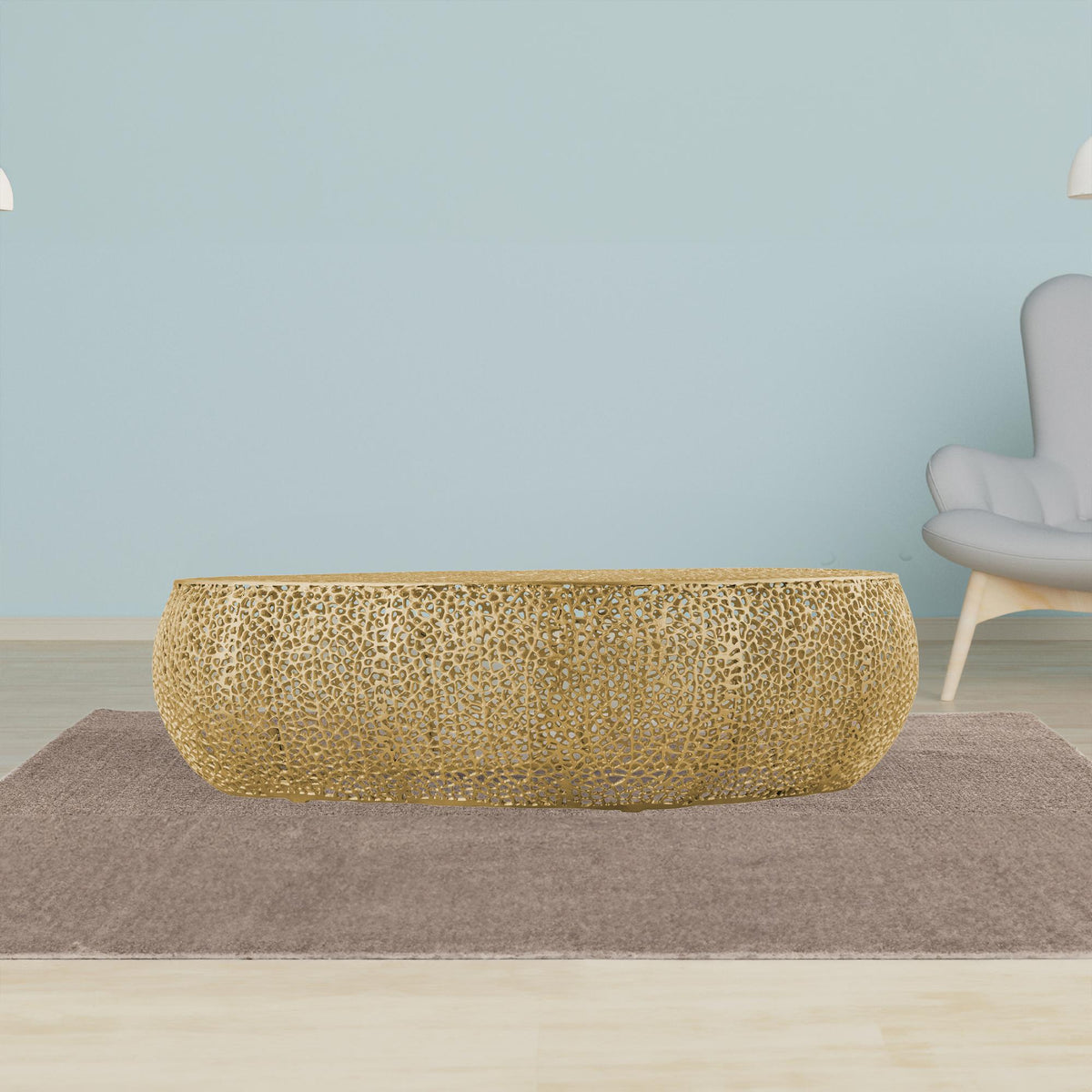 T3601 Gold oval coffee table with an openwork surface against a pale blue wall.