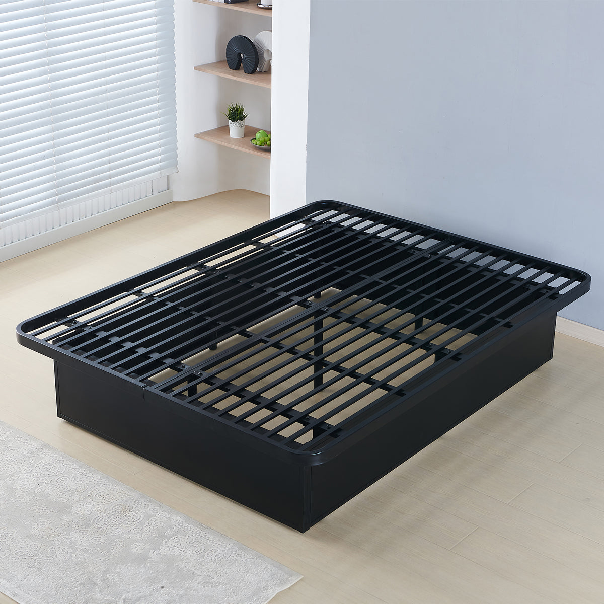 Black metal bed frame with exposed slats in a bedroom; pictured size is unverified. Photographed bed size not verified.