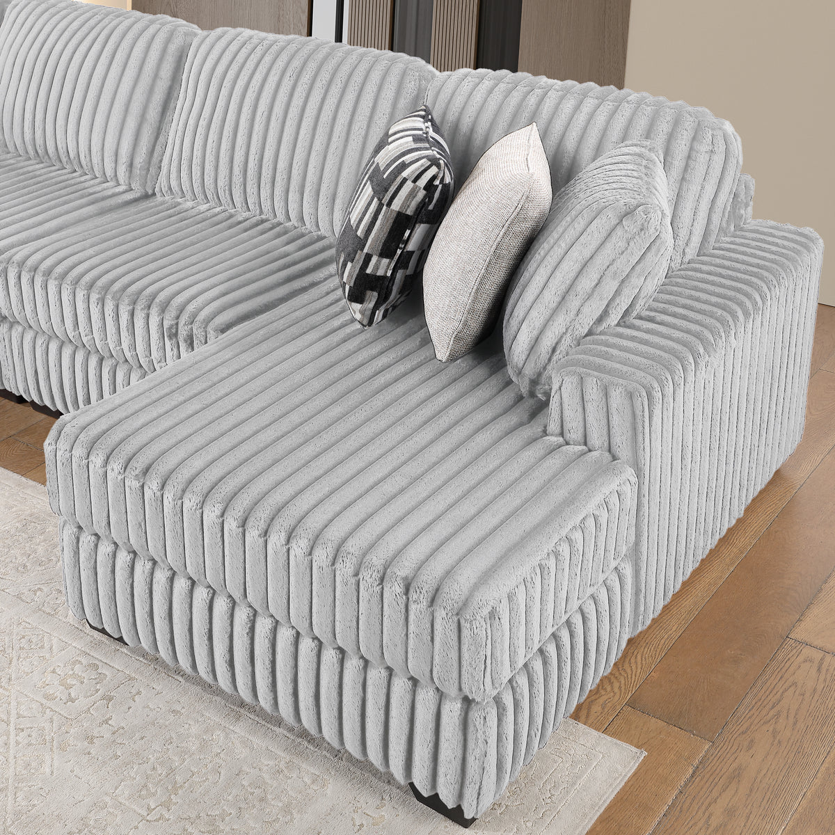 Snuggle Gray Sectional. Snuggle gray chaise upholstery detail. Additional product view.