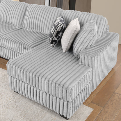 Snuggle Gray Sectional. Snuggle gray chaise upholstery detail. Additional product view.